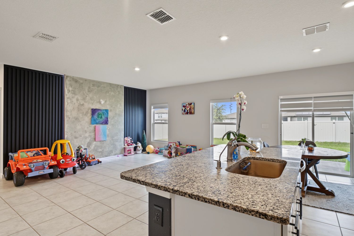 Original: the same space from the kitchen island, with toys along the walls