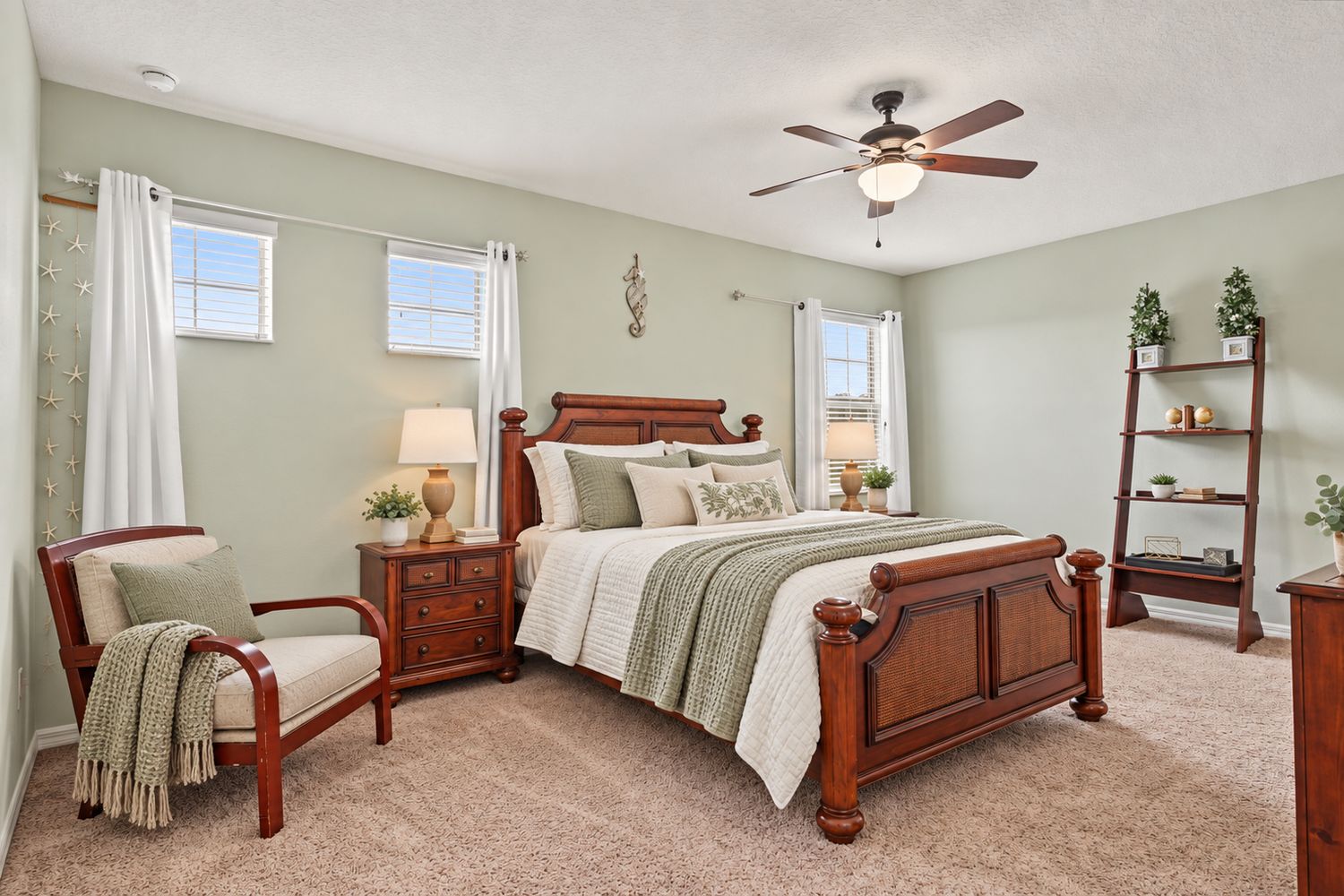Virtually staged: the seller's wood bedroom set with fresh neutral and sage bedding and a new chair cushion