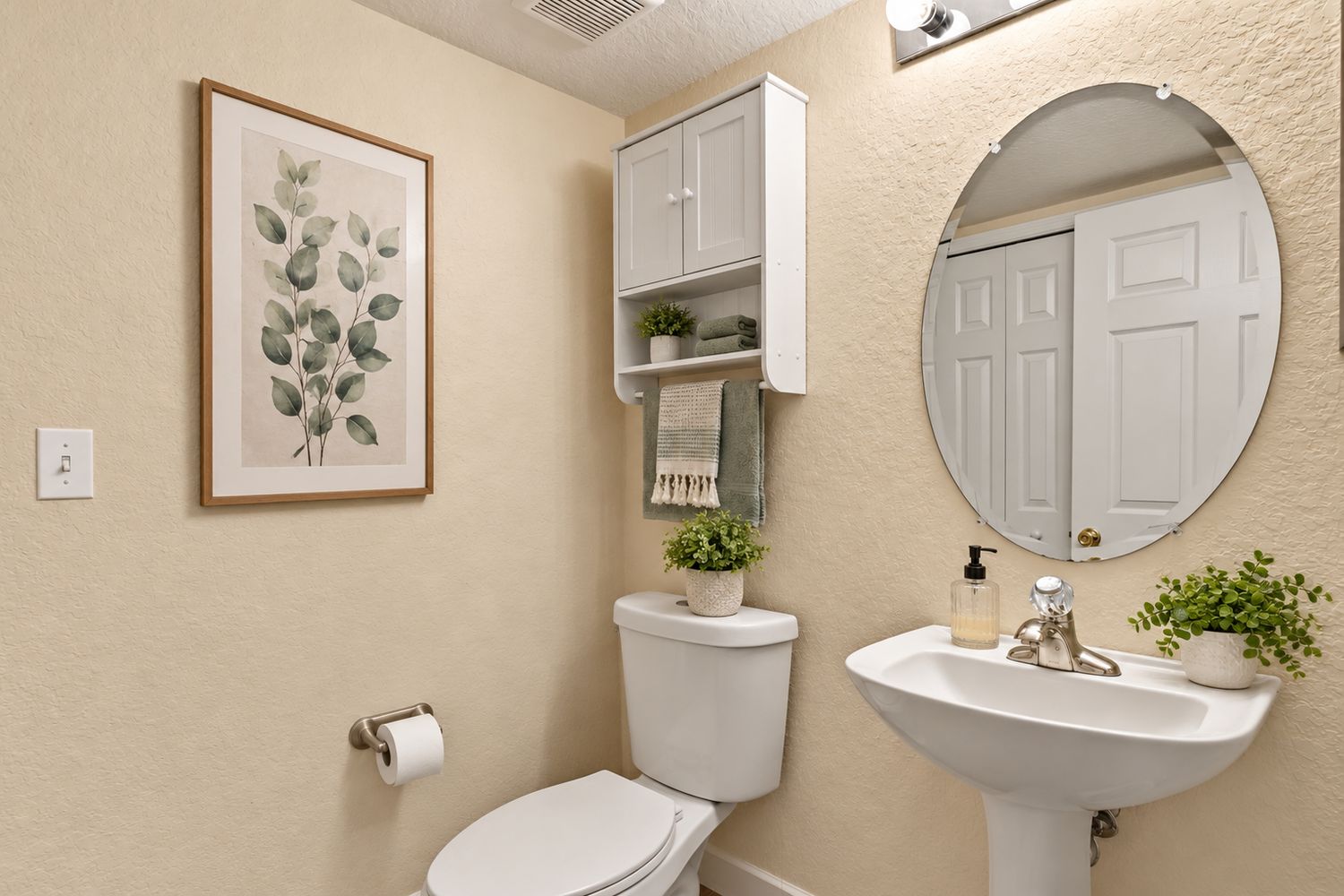 Virtually staged: powder room with botanical art, neutral towels and small plants